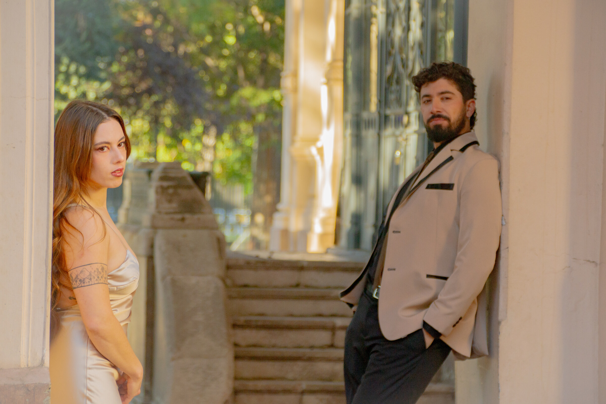 El Dúo Amores de Chile posa con elegancia en los jardines del Palacio Cousiño, con luz de atardecer.